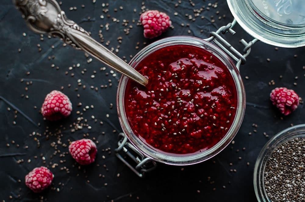 Homemade Chia Seeds Jam Homemade Raspberry Jam With Chia Seeds In A Jar With A Spoon Inside On Black Background.